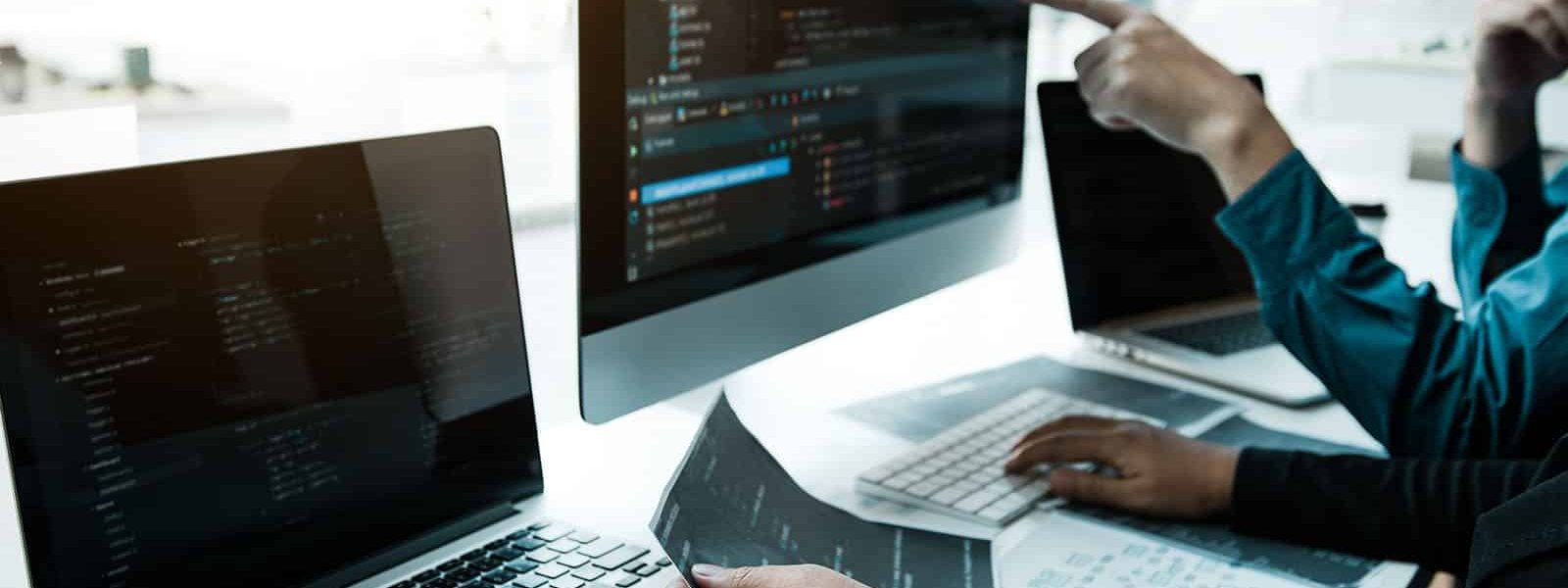 Two asian team working development of programming and encryption technology website design programmers on desk in office.